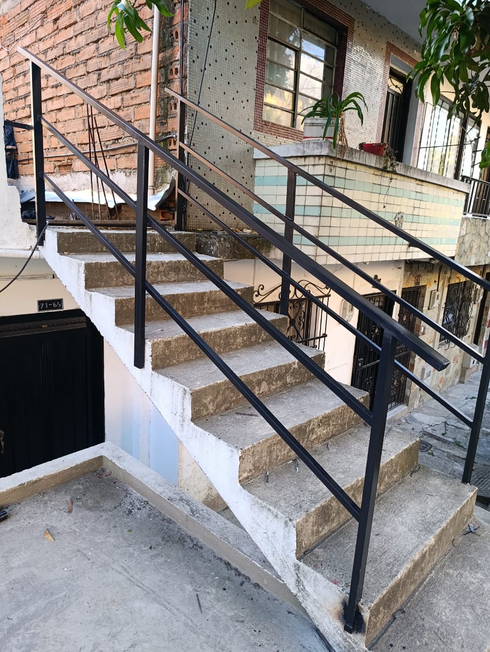 Pasamanos de hierro negro en escalera exterior instalado en Medellín